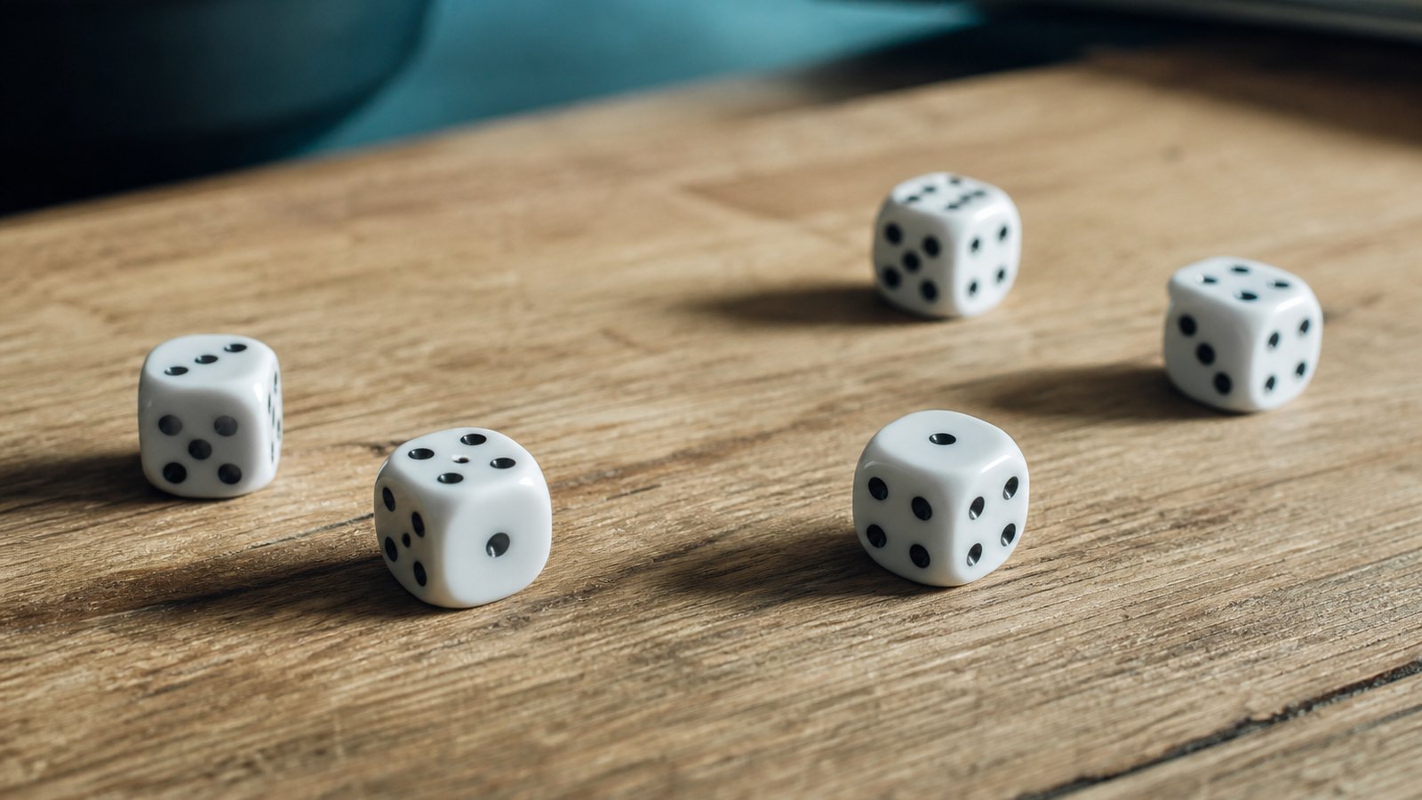 A handful of white dice scattered across a warm wooden tabletop